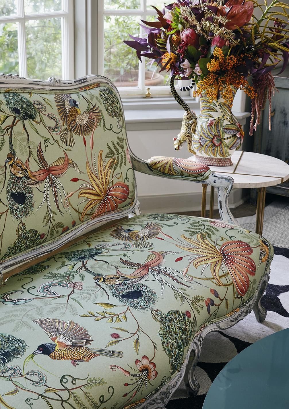 Heritage botanical floral print cushions and vintage textiles in a living room